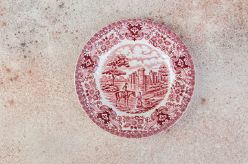 Antique porcelain dish on concrete background.