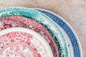 Antique porcelain dishes on concrete background.