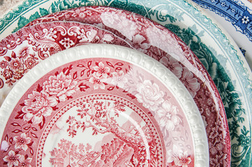 Antique porcelain dishes on concrete background.