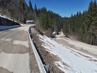 Road in the mountains with snow and pine trees