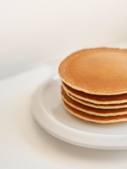 pancakes on white plate on white background