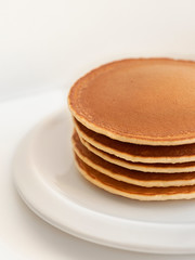 pancakes on white plate on white background
