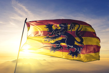 Oudenaarde of Walloon Brabant of Belgium flag waving on the top sunrise mist fog