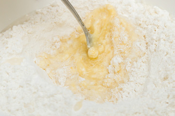 Cooking dough in a white plastic bowl at home