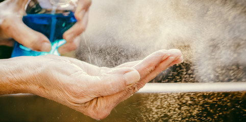 spraying hand sanitizer coronavirus prevention