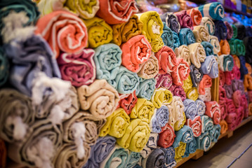 Fototapeta na wymiar folded rolls of towels bed linen Galata Turkish Bazaar fabric