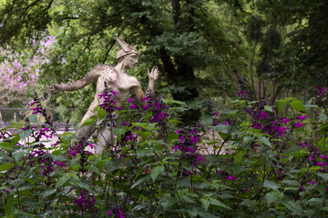 Hermes sculpture in purple garden