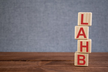 Abbreviation LAHB (left anterior hemiblock) text acronym on wooden cubes on dark wooden backround. Medicine concept.