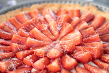 cake with cream and strawberries on a wood table