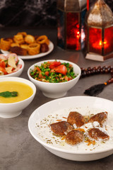 Obraz premium Ramadan. Arabic family dinner. Traditional arabic food. Close-up view. Eid Mubarak. Table with sharing plates food. Ramadan decoration. Lebanese cuisine. Starters, hummus, baklava, dates. Muslim
