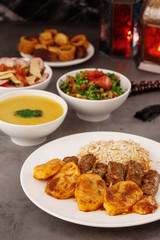 Ramadan. Arabic family dinner. Traditional arabic food. Close-up view. Eid Mubarak. Table with sharing plates food. Ramadan decoration. Lebanese cuisine. Starters, hummus, baklava, dates. Muslim
