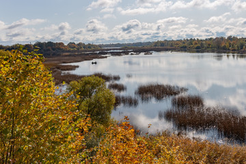 Lake landscape with boat with two fishermen