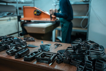 people working with press machinery for cutting shoe leather