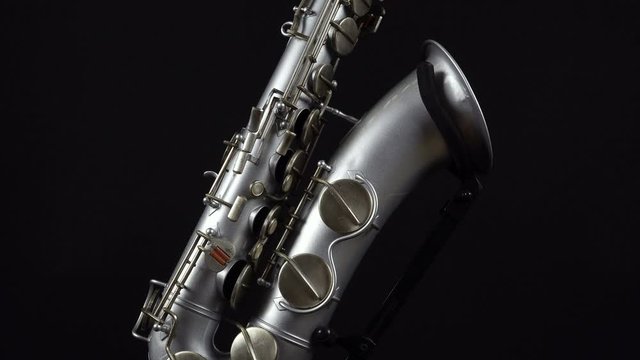 Wind Instrument Saxophone On A Black Background.