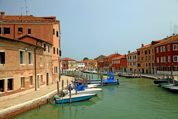 Fototapeta na wymiar A motor boat on the canal on Murano island, Venice, Italy