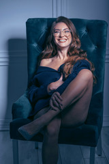 Obraz na płótnie Canvas sensual woman in a chair