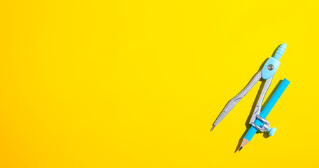 Blue drawing compass overhead view - flat lay