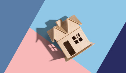 Cardboard house with drop shadow overhead view