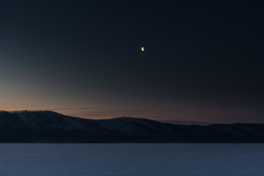 Moon on the night sky above Baikal Lake, Russia
