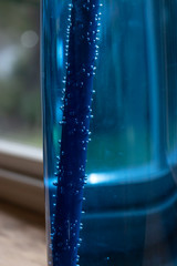 Obraz na płótnie Canvas close up detail of a blue water bottle