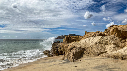Waves crushing at rocks a beach
