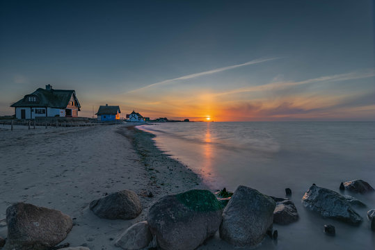 View of the famous beach villas, holiday homes on the beach of the Baltic Sea at sunset in Heiligenhafen, Graswader,Schleswig-Holstein, Germany