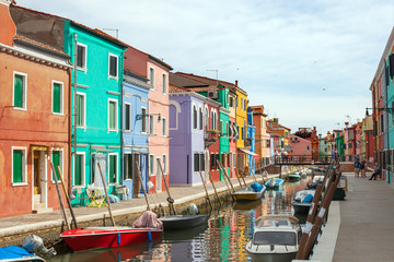 Fototapeta na wymiar Boats on the canal of Burano island (Venice) in summer