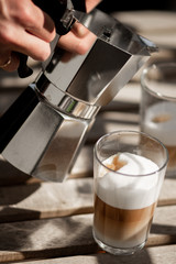 Pouring morning coffee from a Mokka pot