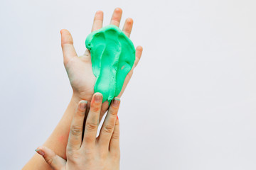 Children's hands play with the sticky mass