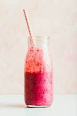 Delicious berry smoothie in a glass bottle