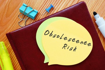 The caption in the picture is Obsolescence Risk. Notebook sheet, table, pens.