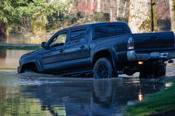 a big truck driving through a flood