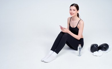 Obraz premium Young woman after boxing workout on a white background.