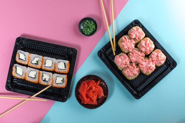 Top view on the plate of rolls with pink cream