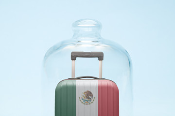 Luggage in isolation under glass cover covid-19 Mexico tourism abstract.