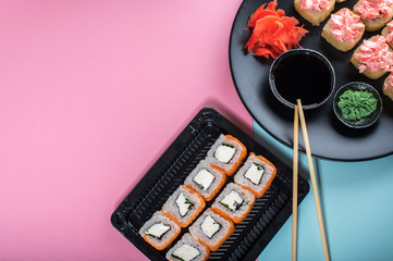 Top view on the plate of rolls with pink cream and Philadelphia roll