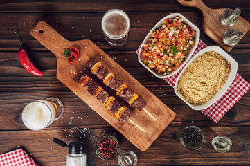 Grilled meat stick with ingredients in top view - Brazilian espetinho de carne