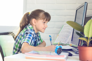 Girl watching a video lesson at home on distance learning