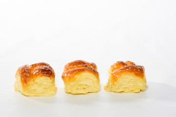 Sweet bread, typical of the Brazilian bakery, on the table on white background with space for text. It has the name of Rosca.