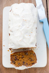 Carrot cake loaf with pecans, raisins and orange icing 