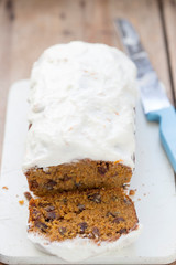 Carrot cake loaf with pecans, raisins and orange icing 