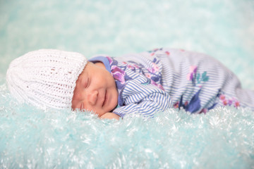 New baby having tummy time on a blue blanket