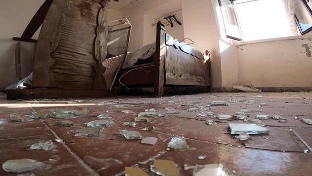 Broken glasses on the floor after a housebreaking in a abandoned house. 4k