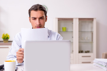 Young male businessman working at home