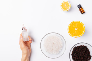 Female hand holding bottle cosmetic serum