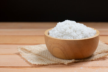 sea salt on wooden plate on wood table.