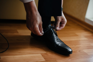 A stylish man wears classic shoes close-up. Fashion