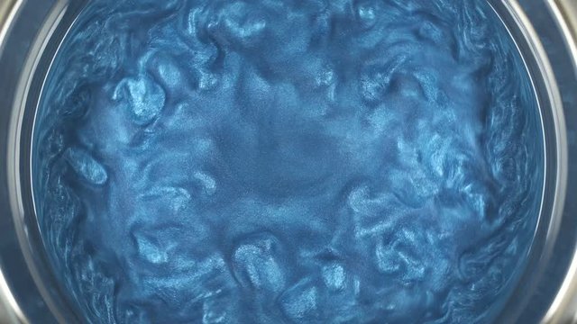 Rheoscopic fluid. Beautiful movement of particles in a liquid. Fantastic patterns and shapes.