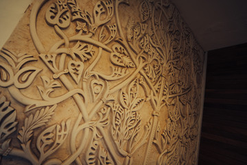 detail of handmade decorative engravings on a stone wall