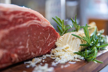 Uncooked Prime Rib cut of beef with grated horseradish root
